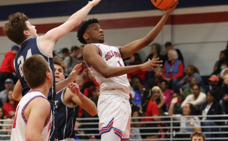 (EMILY DOZIER/THE OGLETHORPE ECHO) OCHS junior Javaun Pittard soars for a shot during the Patriots’ 49-46 victory over Prince Avenue Christian School on Friday night. Pittard led OCHS with 15 points. For more senior night photos and coverage, go to oglethorpeecho.com.