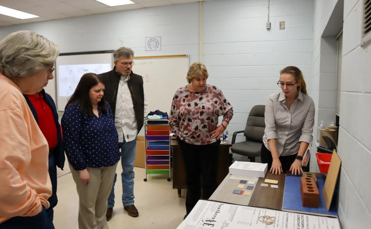 Southern A&E architect Sara Honeycutt shows materials and decor examples to Superintendent Beverley Levine and Board of Education members at the meeting on Tuesday. Honeycutt explained the color choices and how they will be applied. (Photo/Viktoria Kangas)