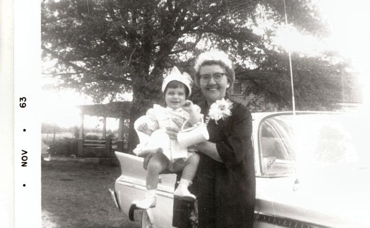 (LINDA HELMLY/PHOTO SUBMISSION) This is Grandma Lee (Parolee Crowe Arnold) (right) and little Linda Helmly (left) in 1963. They are smiling for a photo outside Helmly's childhood home.
