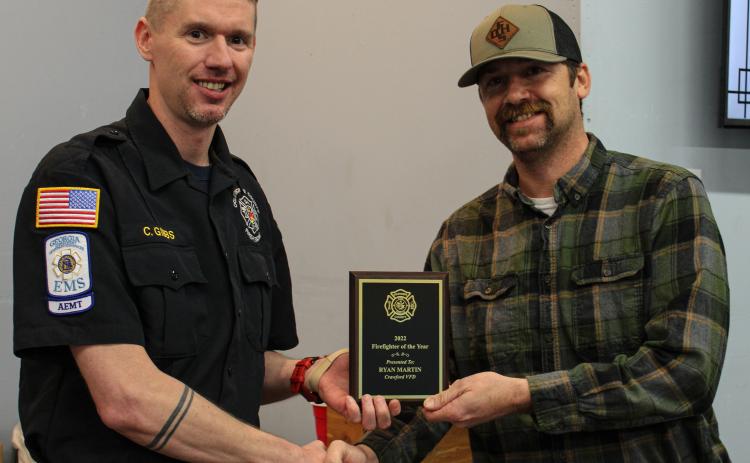 Assistant chief Cody Gibbs (left) gives a Firefighter of the Year award to Crawford assistant chief Ryan Martin at the Oglethorpe County Fire Rescue Banquet on Saturday. Martin also serves as a firefighter for Athens-Clarke County. (Submitted photo/Cody Gibbs)