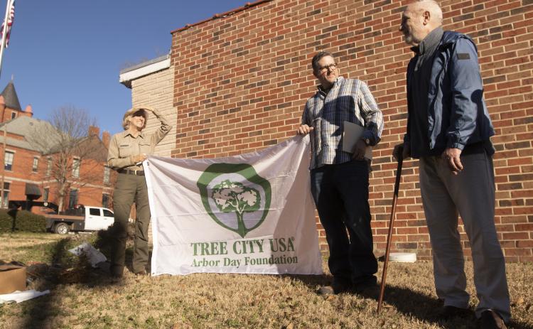 Forester Lea Clark (from left), Lexington Mayor Craig Snow and Ralph Maxwell stand at the spot of the soon-to-be planted red oak by the Lexington Post Office on Saturday. The tree was planted to honor Maxwell, the former publisher of The Oglethorpe Echo. (SOPHIE MCLEOD/THE OGLETHORPE ECHO)
