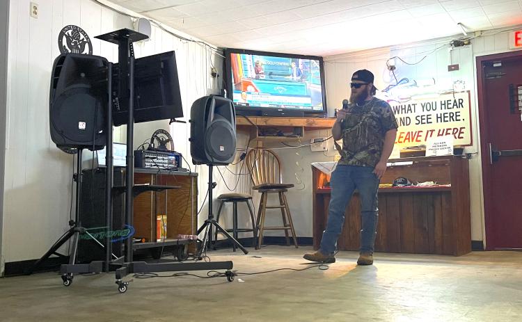Carl Herring sings "God's Country" by Blake Shelton at karaoke night at the James T. Rayle American Legion Post 123 in Lexington. He likes to change the pace by singing recent country hits instead of songs from the 1980s and ’90s. (Photo/Olivia Shapiro)