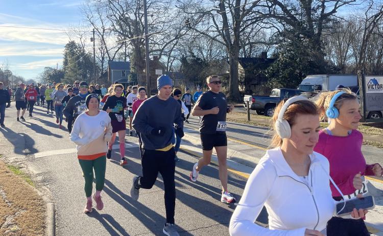 Runners take off at the start of the Winterville Civitan Snowflake 10K on Saturday. There were 210 runners, of which 170 raced in person. (Photo/Olivia Shapiro)