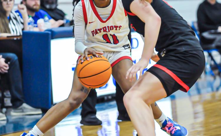 CHARLES JORDAN/FOR THE OGLETHORPE ECHO Denim Goddard dribbles against a Rabun County defender in the Class A Division I tournament. She was the Region 5-A Division I player of the year and led the Lady Patriots to a 20-9 record.
