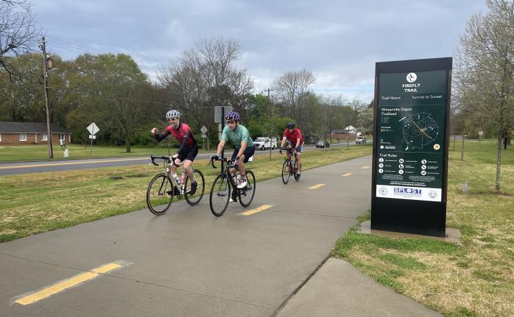 Cyclists participating in the Ticket to Ride fundraiser approach the first stop on the Firefly Trail in  Winterville. Firefly Trail Inc. uses the annual event to raise money to complete the 39-mile path from Athens to Union Point. (Photo/Gray Jones)