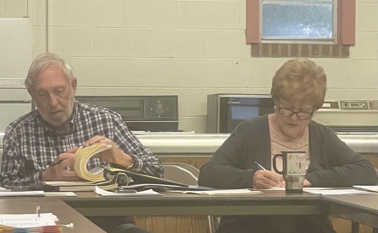 Maxeys Mayor Warren Gilson sits next to clerk Sherry Gilson as the city council discusses slowing traffic through town and other business in its meeting on March 14.