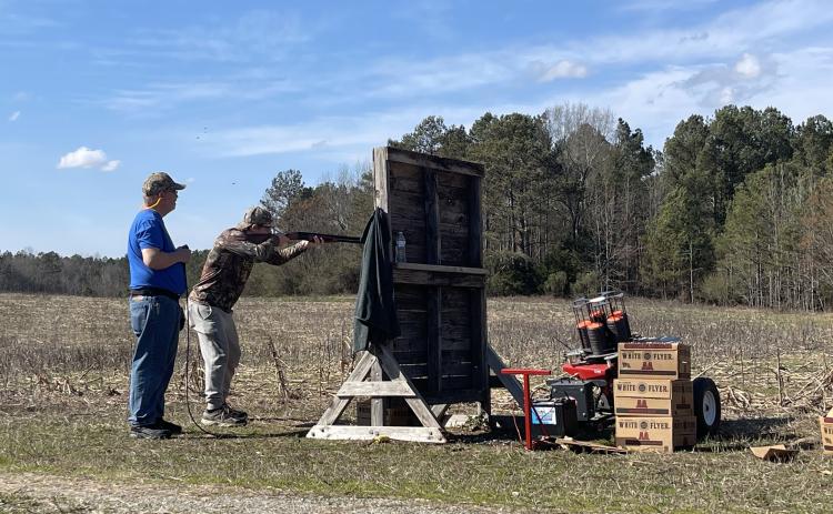 Jacob Spidle, a senior at Oglethorpe County High School, practices with his dad David Spidle, who is one of several coaches with the 4-H shotgun team. Jacob Spidle hopes to finish in the top five at state this year. (Photo/Olivia Shapiro)