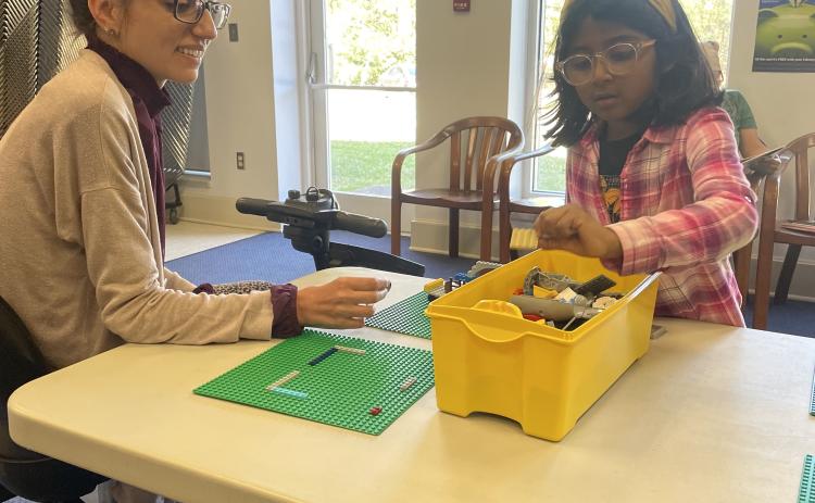 Jessica Ellis (left), who works at the Oglethorpe County Library, and Emma Hernandez (right) chat while Hernandez builds the beginning stages of a treehouse. The library hosts the Lego Club once a month. (RAMON ELORTONDO/THE OGLETHORPE ECHO)