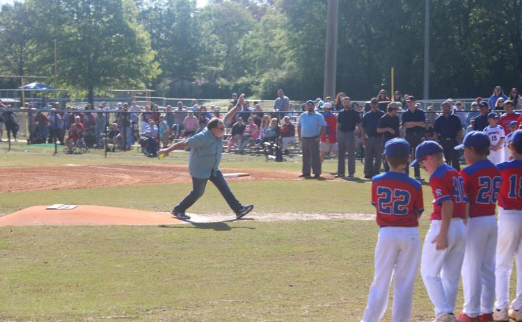 (JACK RHODES/THE OGLETHORPE ECHO) Oglethorpe County resident Elmer Gray, an entomologist with the University of Georgia’s College of Agriculture and Environmental Science, throws out the first softball pitch during Opening Day ceremonies at Bryan Park. Abigail Chappell, a Little League player, caught Gray’s pitch.