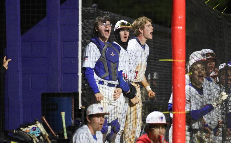 EMILY DOZIER/THE OGLETHORPE ECHO Oglethorpe County’s Daniel Garcia (from left) Austin Lowe and Blane McFarland cheer on their teammates in a 10-9 victory over Clarke Central earlier this season. The Patriots can wrap up the third seed from Region 5-A Division I with a victory over Jasper County.