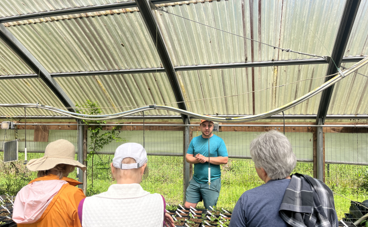 Tanner Biggers highlights the different plant species that are being stored in the greenhouse at Beech Hollow Farm. It uses an irrigation system built into the greenhouses to ensure the health of the plants. JACK RHODES/THE OGLETHORPE ECHO