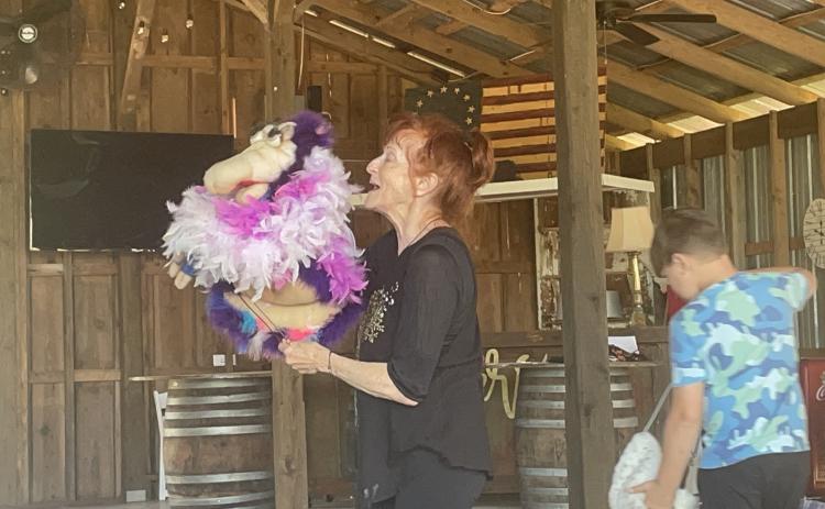 Mary Wooten of the Wooten Woopets leads a dress rehearsal in the barn at Platt Brooks Estate in advance of Saturday’s performance as part of the Downtown Development Authority 2023 Concert Series. Wooten wanted to practice her dance moves to ensure that the audience would be engaged. (SOPHIE MCLEOD/THE OGLETHORPE ECHO)