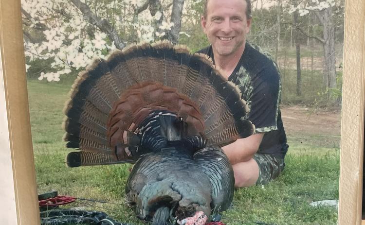 (Alex Bavosa/The Oglethorpe Echo) Andy Nimmons has a photo of himself posing with a turkey he hunted with a bow at his shop, Andy Nimmons Taxidermy, which is in Lexington.