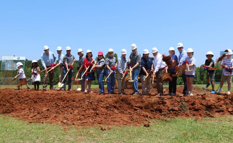 Members of the Oglethorpe County Board of Education, representatives from Southern A&E and Parrish Construction Group, Superintendent Beverley Levine, Principal Katie Baldwin, and students throw dirt with their shovels. (LANDEN TODD/THE OGLETHORPE ECHO)