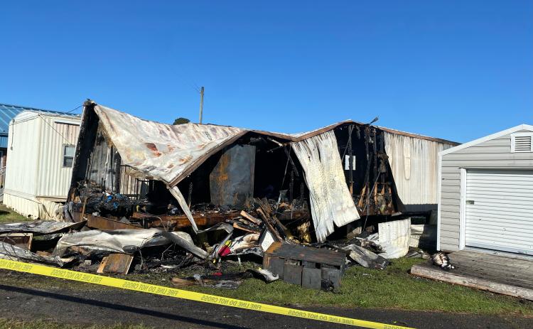 Caution tape surrounds the remains of a storage trailer that burned at Oglethorpe County Elementary School on Monday morning. The trailer contained paper and decorations for themed celebrations. (DINK NESMITH/THE OGLETHORPE ECHO)