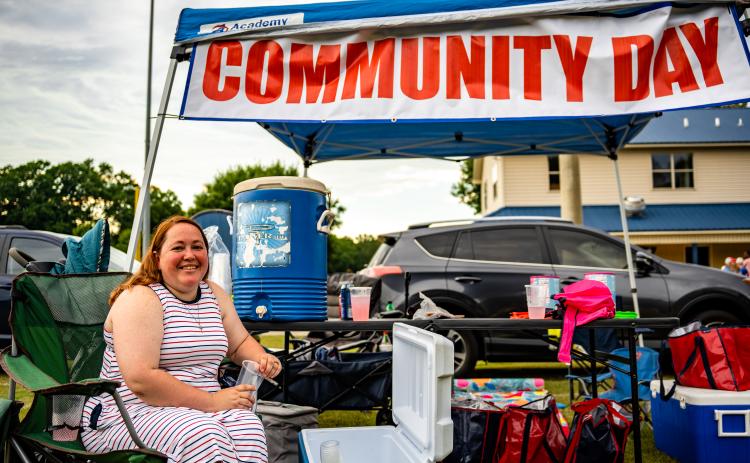 Jeanne Jones staffs the Community Day tent during last year’s Fourth of July celebration at Bryan Park. Community Day is held just before the start of the school year to give supplies to students and help prepare them for the school year. (JACK CASEY/THE OGLETHORPE ECHO)