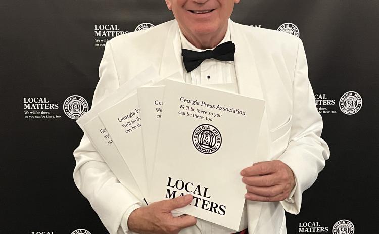 Dink NeSmith, chairman of The Oglethorpe Echo Legacy, Inc., holds the awards that were given to The Oglethorpe Echo at the an- nual GPA Convention on June 9. (SUBMITTED PHOTO)
