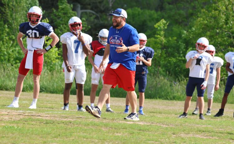 Head football coach Mike Holland encourages his players during spring practice last month. Holland will share AD duties with Brianna Dickens. (LANDEN TODD/THE OGLETHORPE ECHO)