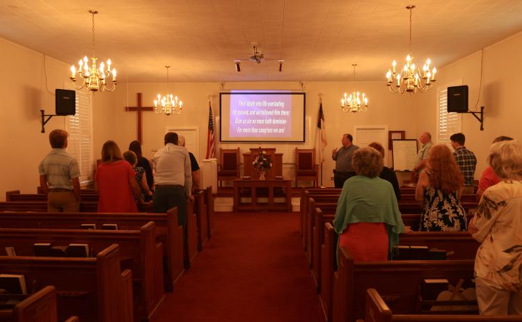 Pastor Ken Keely leads the congregation in worship as the church in Stephens celebrates its 210th anniversary on Sunday. The church, which was established in 1813, had a potluck lunch after the service and was scheduled to hold three nights of revival services this week. (LANDEN TODD/THE OGLETHORPE ECHO)