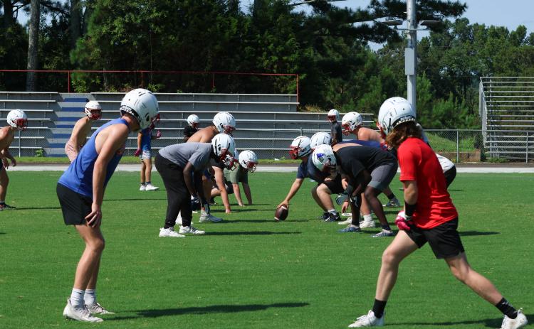The Oglethorpe County football team lines up to run a play during practice on Monday morning. The Patriots can begin practicing in pads on July 31. (LANDEN TODD/THE OGLETHORPE ECHO)