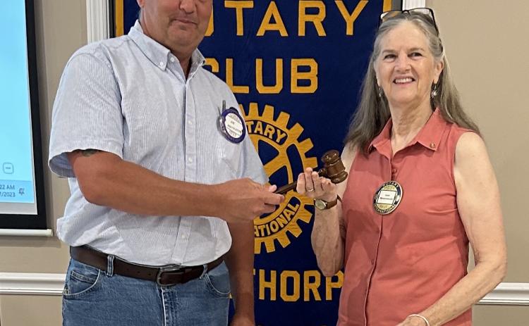 Joe Holtzleiter, the outgoing Rotary Club president, hands the gavel to new club president Jean Westmacott earlier this summer. (SUBMITTED PHOTO)