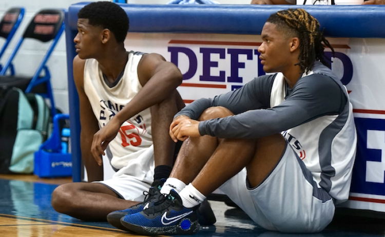 Ty Burgess (left) and Jordan Johnson wait during a break in the action to check into a summer league game. Johnson has displayed “defensive intensity and effort,” OCHS coach Larry Brown said. (SUBMITTED PHOTO)
