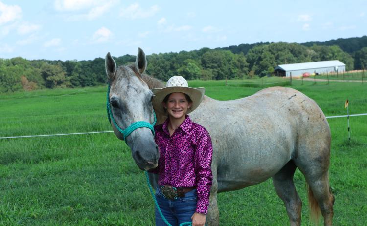 Kenzie Erwin, along with her horse Badger, has won three belt buckles in the 2022-23 season for her rodeo skills, which include goat tying and barrel racing. (LANDEN TODD/THE OGLETHORPE ECHO)