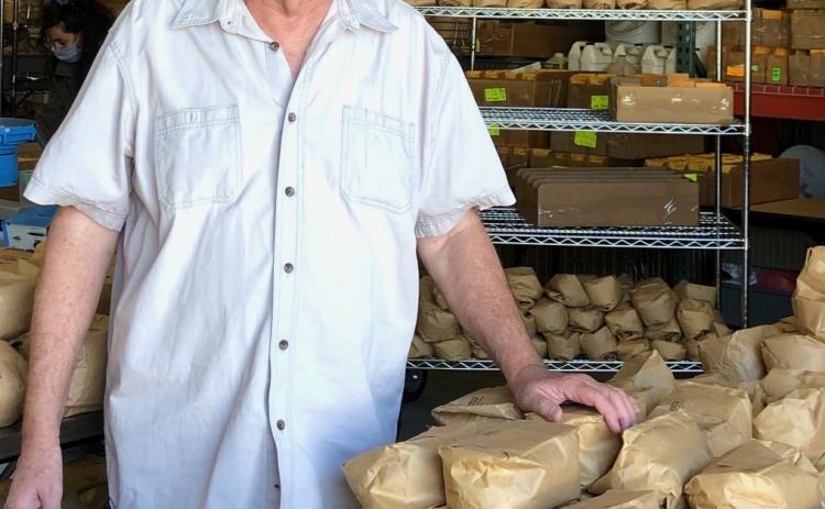 Tommy Carter in his lab with bags of soybeans he developed just before he retired from North Carolina State in 2019. Carter’s family has roots in Oglethorpe County dating to the 1800s. (SUBMITTED PHOTO)