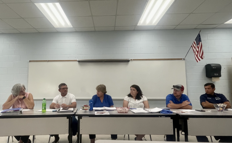 Members of the Board of Education (from left) Susan Robinson, Tim Poole, Superintendent Beverley Levine, BOE Chair Becky Soto, Jake Willcox and Guillermo Camacho discuss matters at the BOE meeting on Tuesday night. (JULIANNE AKERS/THE OGLETHORPE ECHO)