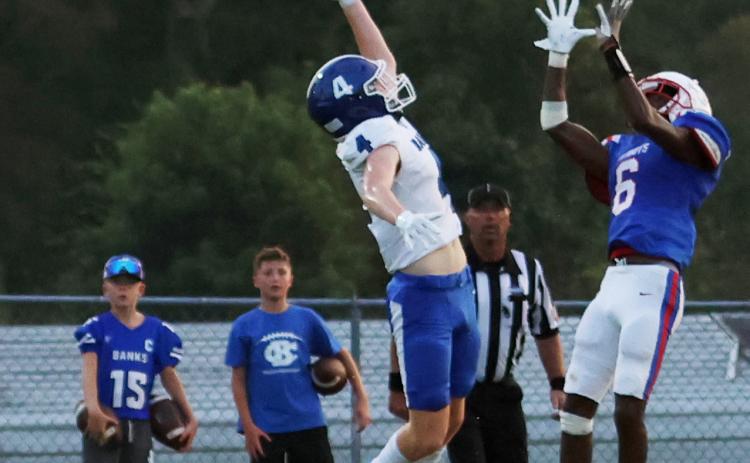Oglethorpe County’s Darius Heard leaps to pull in a 13-yard touchdown pass over Banks County’s Caden Watson for the Patriots’ first touchdown in their 19-14 loss to Banks County in Lexington on Friday night. (NOOR ABDALLAH/THE OGLETHORPE ECHO)