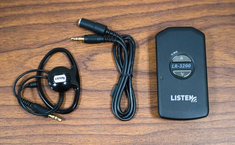 Receivers, lanyards and speakers are components of the Listen EVERYWHERE receivers that are available at the Oglethorpe County Library. The library’s staff is available to assist visitors with the new technology. (Sidney Chansamone/The Oglethorpe Echo)