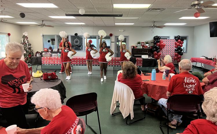 (Tyler Blount/The Oglethorpe Echo) xUGA cheerleaders led the cheers as part of Calling the Dawgs at a tailgate event at the Oglethorpe  County Senior Center on Sept. 1, in advance of the Bulldogs’ first game last weekend. The event also  featured music and food
