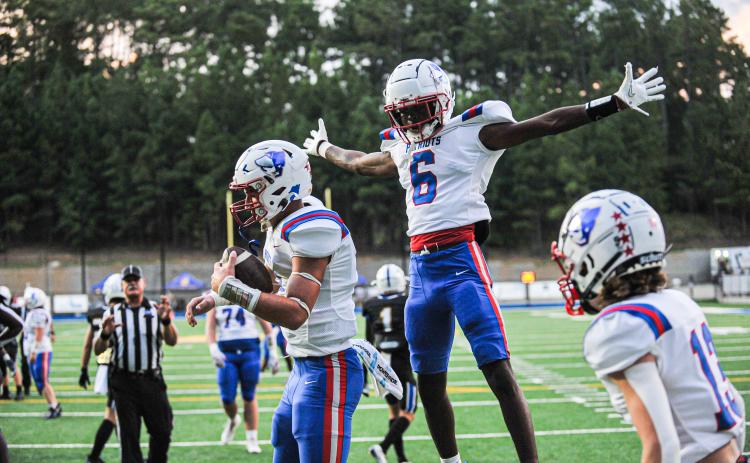 Darius Heard (No. 6) enjoys the moment after Jake Turner (left) scores a touchdown in Oglethorpe County's 20-7 victory over Lake Oconee Academy last Friday. The Patriots host Greene County at 7:30 p.m. Friday night. (CHARLES JORDAN/FOR THE OGLETHORPE ECHO)