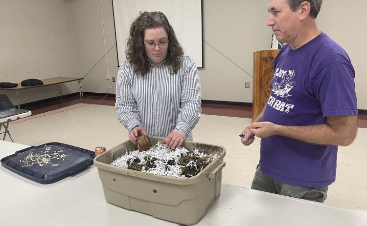 Amanda Tedrow and Patrick Phelps discuss Tedrow's compost bin, which includes dirt, paper scraps, vegetables and worms. She showed the box at the UGA Extension Office’s second annual Fall Garden Workshop in Lexington on Aug. 31. (Photo/John Henry Hammond)