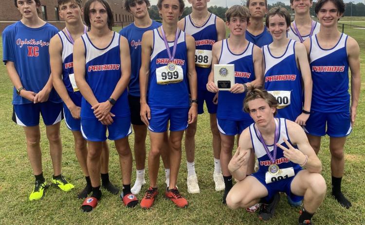 The OCHS boys cross country team consists of Nathen Reesman (from left), Landon Mallonee, Dominic Piscitelli, Ethan Dodd, Cory Tillman, Logan Tatum, Peyton Duvall, Phil Paradise, Josiah Young, Ethan McLean and Luke Holbrooks, and Logan Grier (front).