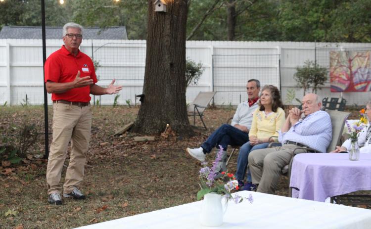 Arnoldsville City Councilman Danny Sniff (left) gestures toward Mayor Pro Tem Danny Morcom (far right) at the Arnoldsville meet and greet last Friday at No. 3 Railroad Street. Both men are running for mayor, but have shown respect and goodwill toward each other. “Am I endorsing Danny?” Sniff said. “To some degree, yes.” (photo/ Elena Acosta)