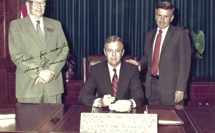 Larry Walker Jr. spent 32 years in the Georgia House of Representatives. One of many achievements was to persuade the General Assembly and the governor to build improved fair facilities. In this 1985 photo, Gov. Joe Frank Harris, center, signs the legislation creating the Georgia Agricenter. On the left is Rep. Henry Reaves, chair of the House agriculture committee. On the right is Rep. Larry Walker Jr. The bill paved the way for the Georgia National Fair complex in Perry, Walker’s hometown.