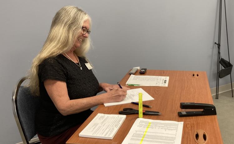 Dana Player, Arnoldsville city clerk and elections superintendent waits to check in voters at City Hall earlier this week. Early voting for the general and special elections began on Oct. 16, and Election Day is Nov. 7.