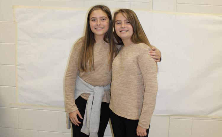 Rileigh (left) and Raina Giles pose together for twin day. The two seventh graders are actual twin sisters. (Photo/Caleb Baldwin)