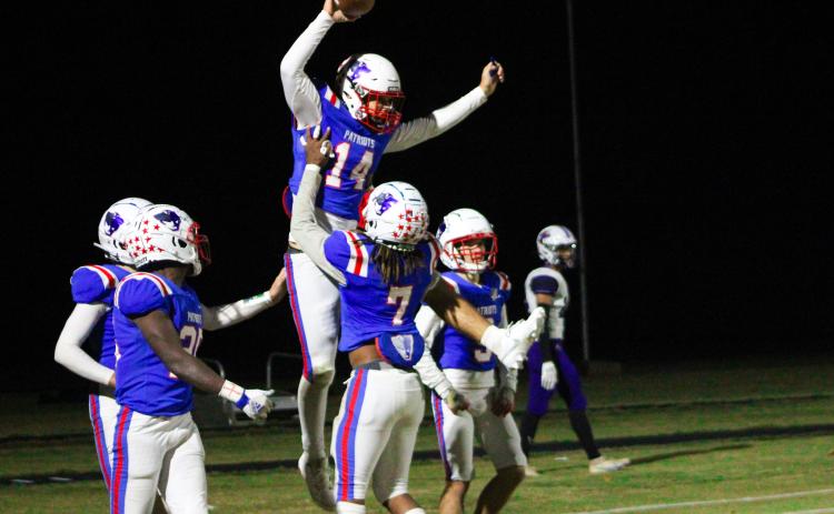 Ashton Sexton (14) gets lifted into the air by Keymon Pass (7) after scoring the game-winning touchdown to defeat Jasper County 35-28. Both players were honored before the game during the senior night ceremony. (Lauren Hill/The Oglethorpe Echo)