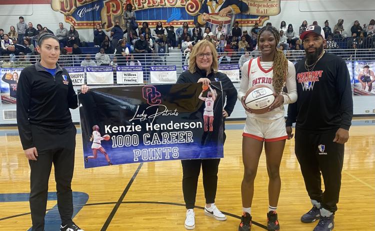 OCHS girls coach Brianna Dickens (from left), assistant coach Cindy Roach, Kenzie Henderson and assistant coach George Gresham commemorate Henderson’s 1,000 career point. (Submitted Photo)