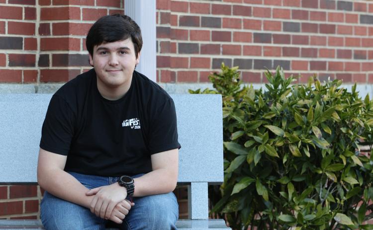 Nathan Wilson poses on a bench outside of Oglethorpe County High School on Jan. 31, 2024. Nathan Wilson was chosen as a finalist for the 2024 Questbridge scholarship. (Photo/Jim Bass)