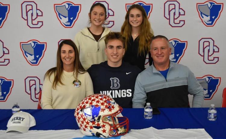 OCHS running back Jake Turner signed a letter of intent to play football at Berry College on Feb. 14. He’s joined by his mom Kristina, sisters Elin and Georgia, and dad John at the OCHS cafeteria. (Submitted Photo)