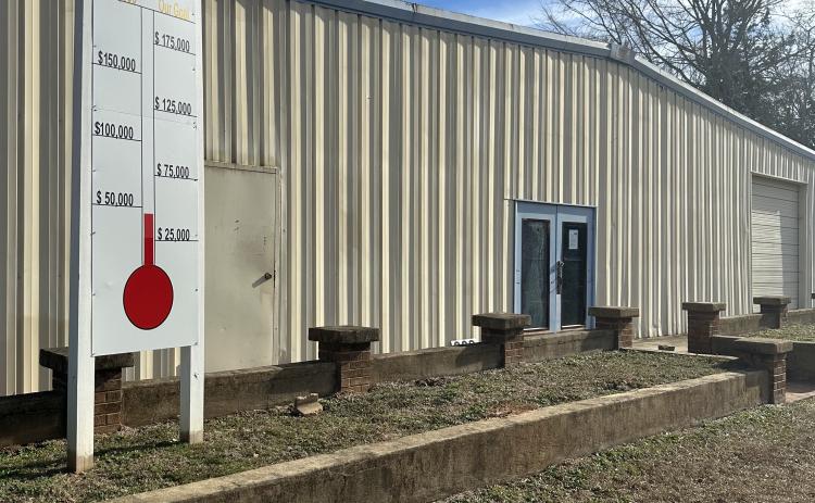 The fundraiser thermometer outside the Macon Coil building has been filled in to show that $65,000 has been raised to turn the facility into the Lexington Community Center. The goal is $200,000. (Jordan Howard/The Oglethorpe Echo)