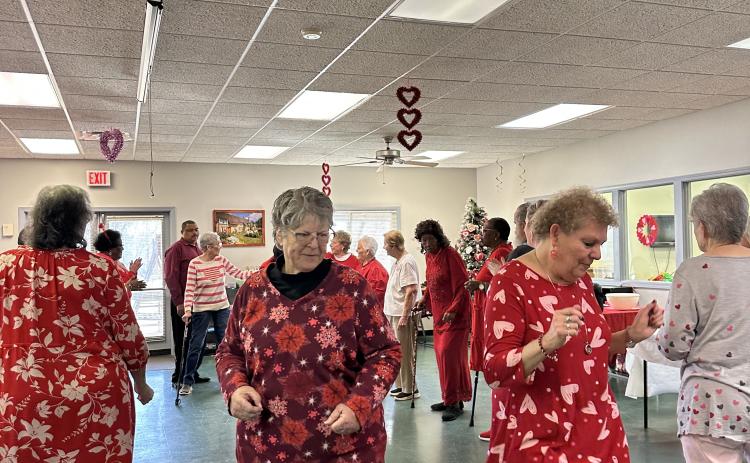Debbie Winsett (right) and Rosanne Iturrian (left) make their way down the soul train line in a dance to Love Train by The O'Jays. This dance was a crowd favorite during the Valentine's Day event. (Lily Murphy/Oglethorpe Echo).