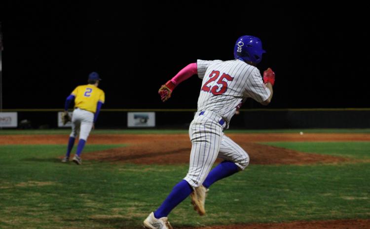 Outfielder Haiden Ashworth heads to first after getting a hit against Lake Oconee Academy last week. He leads OCHS with a .519 average and 13 RBIs through eight games. (Owen Warden/The Oglethorpe Echo)