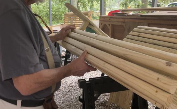 Ross Dudley holds a swing that’s in progress at his Moss Creek  Swings workshop. The former Athens-Clarke County fireman said  he stays backed up with orders. (Chloe Beaver/The Oglethorpe Echo))