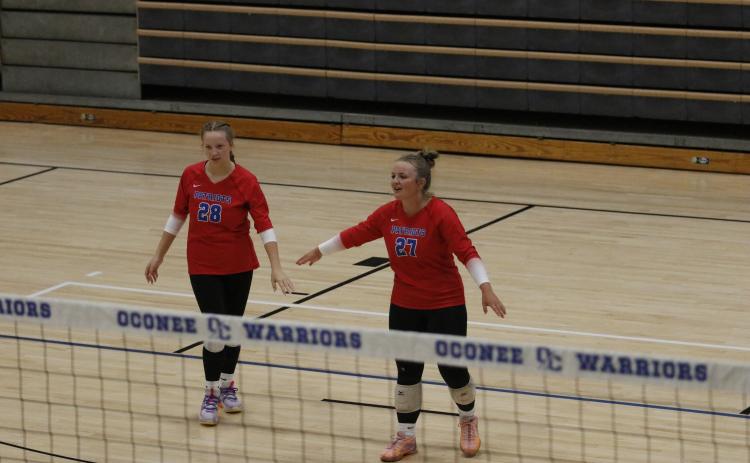 Seniors Samantha Amos (28) and Sofia Horsley (27) helped lead the Oglethorpe County volleyball team to the Elite Eight of the Class A tournament. They joined Kenzie Henderson as the team’s only seniors. (Torin Smith/The Oglethorpe Echo)