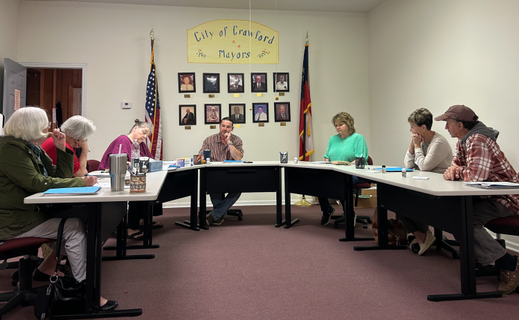 The Crawford City Council’s Sandra Sheridan (from left), Brenda Butler, city clerk Amy Wall-Lance, Mayor Seavy O’Neal, Kathy Little, Carol McGrath and Johnny Shedd unanimously decided to update the city’s budget in accordance with the waste water department by $1,440 a year on Tuesday night. (Photo/ Sarah Coyne)