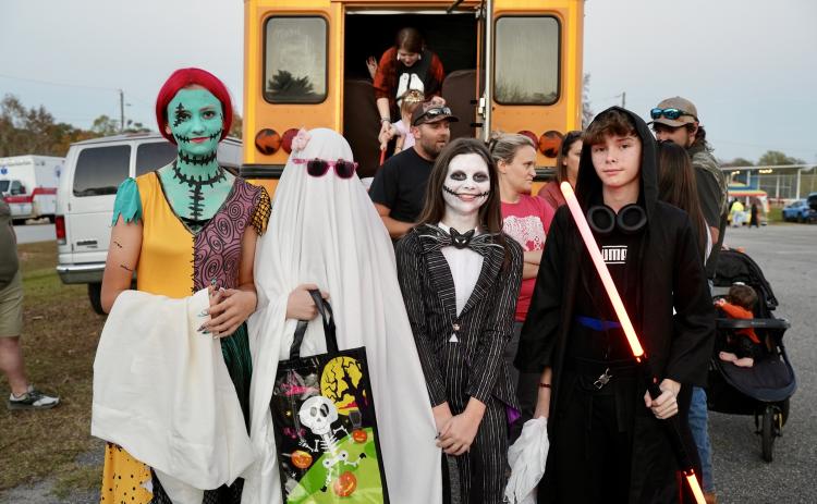 Rylee Stanley (from left), Rebecca Jones, Kinley Grimes and Julian George went all out for the rec department’s Trunk or Treat. The eighth-graders stand in front of one of the night’s biggest attractions: Ms. Frizzle’s Magic School Bus. (Saylor Williams/The Oglethorpe Echo)